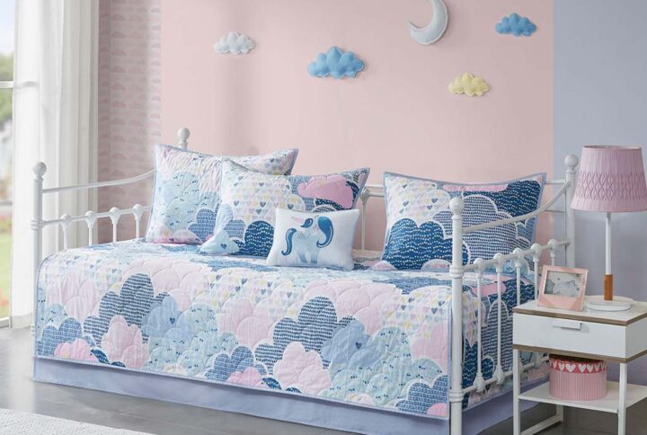 Drift off to dreamland with the whimsical charm of the Urban Habitat Kids Cloud 6 Piece Cotton Reversible Daybed Set. The daybed showcases a cute and fluffy cloud motif in a soft colorful palette with a solid reverse. The 3 shams mirror the design of the comforter and reverses to solid blue to perfectly complement the top of the bed. An embroidered decorative pillow with an adorable unicorn and a solid bed skirt add delightful finishing touches. Made from 100% cotton