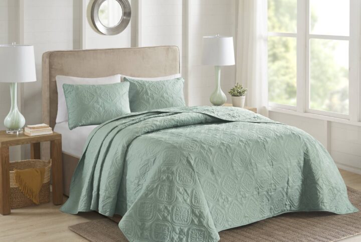 This 3 Piece reversible bedspread set offers a simple and stylish addition to your bedroom decor. A quilted medallion technique is displayed on the seafoam bedspread and shams
