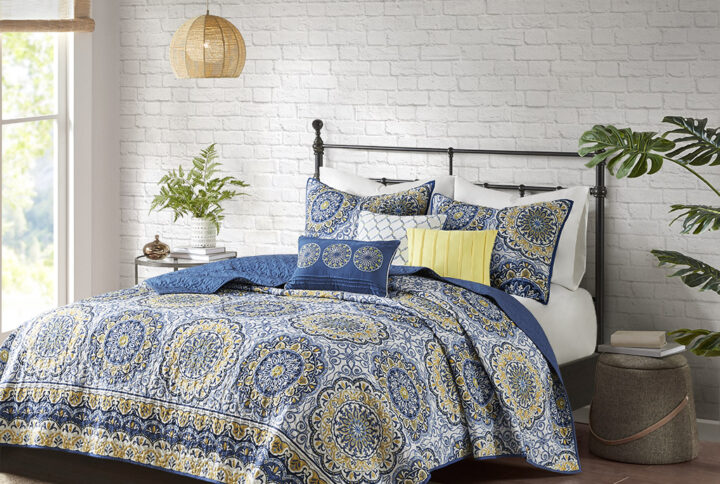 Tangiers 6 Piece Reversible Quilt Set instantly adds color and flair to your bedroom. Its bold blue and yellow floral print with large medallions is a modern twist to a classic look. The embroidered detailing on the three decorative pillows pulls the whole look together. This quilt set also includes two matching standard shams. With a microfiber polyester face and a brushed fabric reverse