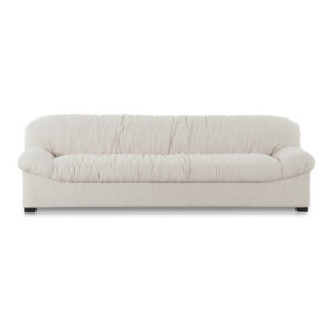 The oversized Halston sofa evokes a nostalgic 80s aesthetic through the relaxed