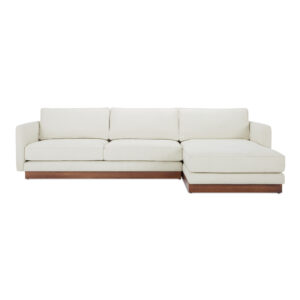 The Vernon sectional blends mid-century design with modern functionality. It features a wooden plinth base for an elevated