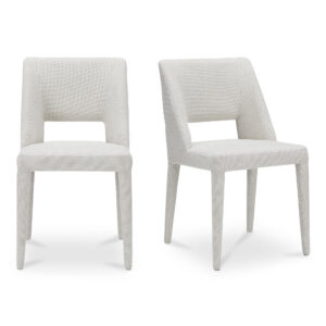 The Joyce dining chair's fully upholstered silhouette flows seamlessly from seat to base