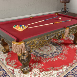 Introducing our ultimate in grand style The Regal Monarch Pool Table Professional. Hand carved and hand finished recreations of elegant Pool Tables. The Regal Monarch design offers a massive scale and is carved in 100 % solid wood with dramatic hand-carved lion heads on each leg and connected with a carved skirted apron. 100% Hardwood Construction featuring massive carved Lion legs