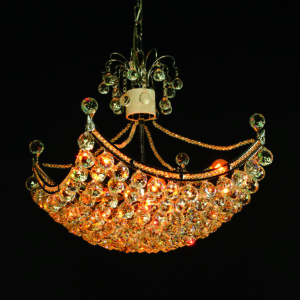 Crystal spheres and gold plating highlight this beautiful chandelier. Elegance and sophistication are abound in the craftsmanship and details of this striking pendant shaped fixture. A beautiful addition to any home. This chandelier requires 8 -40W -E12 bulbs
