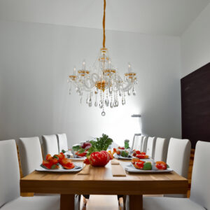 set in a robust steel frame with graceful glass accents. The combination of its radiant crystals and gold finish provides a luxurious glow