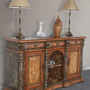 The Peruvian Iron Scroll Buffet is 76" wide and 44.5" tall. It features hand forged iron arched doors with hand hammered locking hardware and key