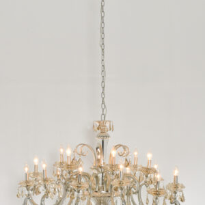 Step up the scale of your decor with the Hollywood 18 Light Chandelier. This medium-sized chandelier dazzles with eighteen lights and is designed to make a statement in larger rooms such as grand living spaces or luxurious dining rooms. Its brushed silver frame is enhanced by the deep