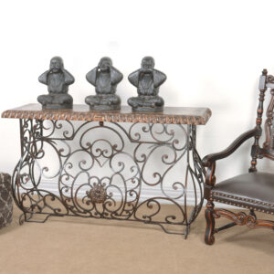 this stately console combines the skills of the master blacksmiths and cabinet makers. It has a Spanish influence with a shapely and flowing base done in hand forged iron and a thick rope edged top in a multi layered finish of light and dark sienna and brown tones with subtle natural contrasts resulting from hand rubbing and exposing the rich wood undertones. There are many matching items offered in Santa Lucia collection for the creation of a uniquely themed room setting. The Santa Lucia Collection consists of handmade