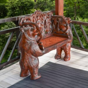 a stunning accent piece made of durable resin and wood. Featuring two intricately carved standing bears holding up the bench with detailed foliage accents