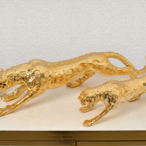 the artists depicted this animal in a prowling position showing movement. Hand cast in ceramic and resin. Features a striking gold plated finish.