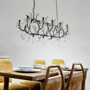 this luxurious chandelier features a sleek smoked stainless steel frame beautifully accented with cascading crystal prisms and faceted crystal drops that reflect light with dazzling brilliance. The elegant curved arms and sparkling crystal detailing create a refined balance of contemporary style and classic European inspired elegance.