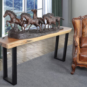 Offering a Natural Suar Live Edge Console 78 Inches Long with square Iron Legs. The extra long length requires finding the right specimen of the Suar wood. Suar often referred to as Oriental Walnut for its contrast between the darker heart of the center wood and lighter outer bands is a plentiful species. Also referred to as Monkey trees these big creations of nature grow tall and have large canopies that the local inhabitants love to hang around under. The black cast iron square legs enhance the cleaner style and create a strong base. The top is left Natural with clear top coating. Minor assembly of legs to base required! Imported from Indonesia!