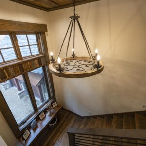 which pairs rustic style with unique design elements. This chandelier features a brown distressed solid wood frame and vintage black rust handmade finished metal components