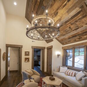 15-light fixture boasts a distressed solid wood frame and handmade vintage black rust finished metal components