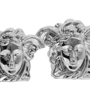 The Medusa set of 2 vases are finely cast in ceramic and hand finished. Each table vase has been cast using hand carved molds with attention to detail in capturing the essence of Medusa. Reflections from the mirrored finish dance over the surfaces highlighting shadows that enhance the three-dimensional depth of the vases. Suitable for use with faux flowers