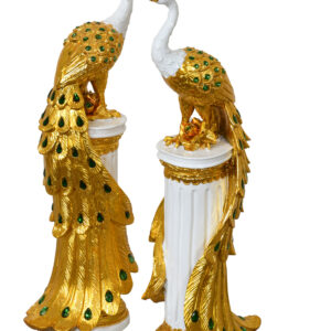 The European Elegance Golden Emerald Peacocks on Pedestal Set of 2 is a stunning addition to any decor. These decorative statuary feature peacocks perched atop Corinthian-style pedestals adorned with French White and green rhinestone crystals. Their elegant and captivating design makes them easy to decorate with
