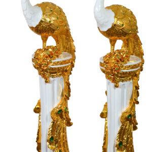 The European Elegance Golden Emerald Peacocks on Pedestal Set of 2 is a stunning addition to any decor. These decorative statuary feature peacocks perched atop Corinthian-style pedestals adorned with French White and green rhinestone crystals. Their elegant and captivating design makes them easy to decorate with