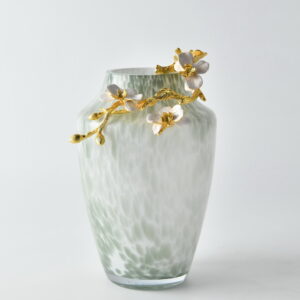 Elevate your interior styling with the Pearl Blossom Vase with Gold Floral Branch. This exquisite vase features a soft sage and white speckled glass body that mimics the look of fine porcelain