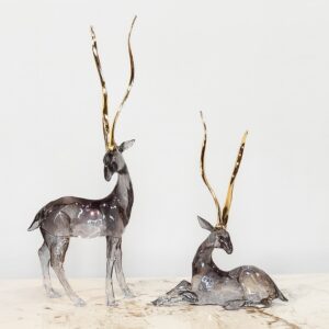 Embrace serene elegance with the Set of 2 Stag with Gold Antlers Sculptures